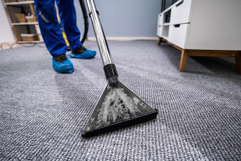 Extraction wand pulling water out of soaked carpet